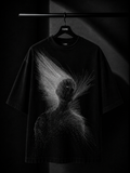 Black oversized T-shirt featuring a minimalist white abstract line-art graphic on the back, displayed on a premium wooden hanger in a dark luxury studio setting.