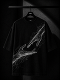 Black oversized T-shirt featuring a white abstract wireframe graphic of two hands reaching toward each other, displayed on a premium wooden hanger in a dark luxury studio setting.