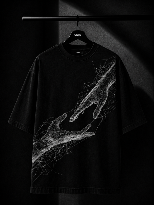 Black oversized T-shirt featuring a white abstract wireframe graphic of two hands reaching toward each other, displayed on a premium wooden hanger in a dark luxury studio setting.