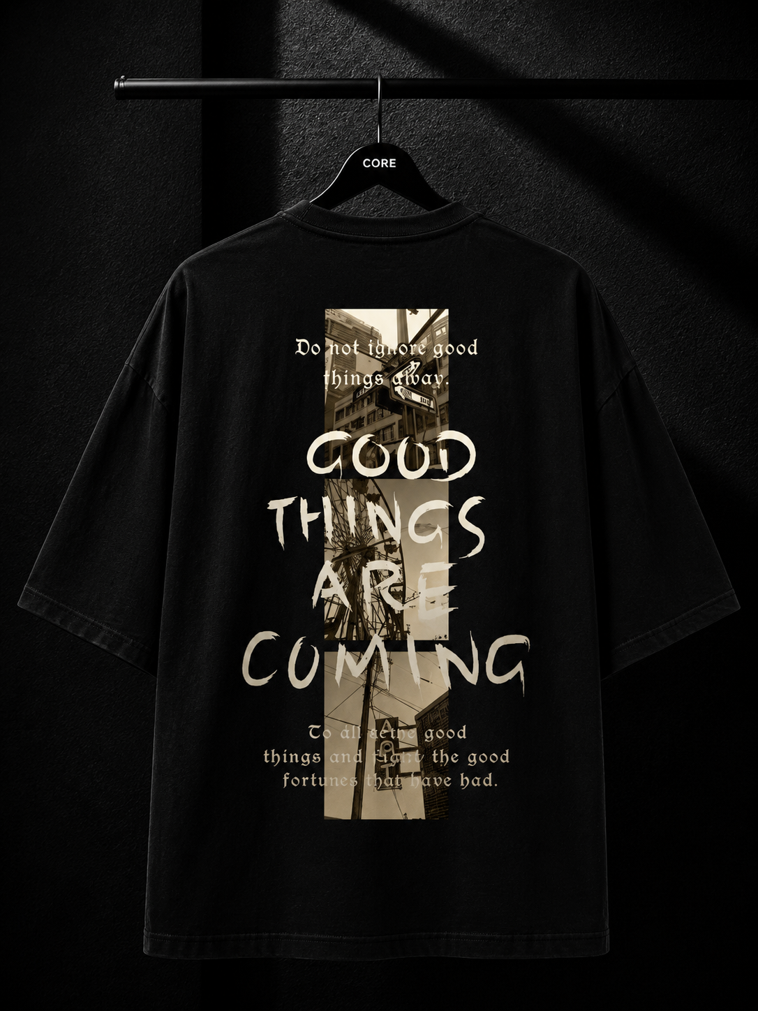 Black oversized T-shirt with a white maple leaf graphic cascading from the right shoulder in a premium minimalist streetwear design.