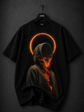 Black oversized T-shirt featuring a surreal hooded figure with a glowing molten face, fiery halo, and dark cosmic aesthetic printed on the front.