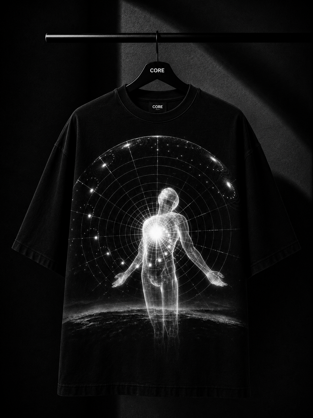 Black oversized graphic T-shirt with a minimalist white botanical leaf design cascading from the right shoulder, displayed on a premium wooden hanger against a dark luxury studio background.