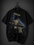 Premium black oversized graphic T-shirt featuring a surreal hooded figure with a faceless cosmic silhouette, glowing molten orange energy, and a radiant fiery halo printed on the front.