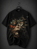 Premium black oversized graphic T-shirt featuring a surreal cracked stone head with a powerful ocean scene flowing through it, creating a dramatic waterfall effect in vivid blue tones on the front.